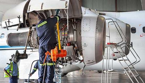 Aviation Maintenance Technician working on airplane